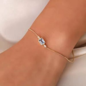 1.00 Carat Bezel Set Emerald Shaped Aquamarine Bracelet  With Baguette Cut Diamond As A Sidestone
