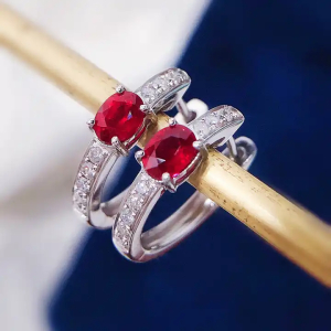 0.75 Ruby Oval Shaped Stone In the Middle And Round Diamonds As a Side Stone