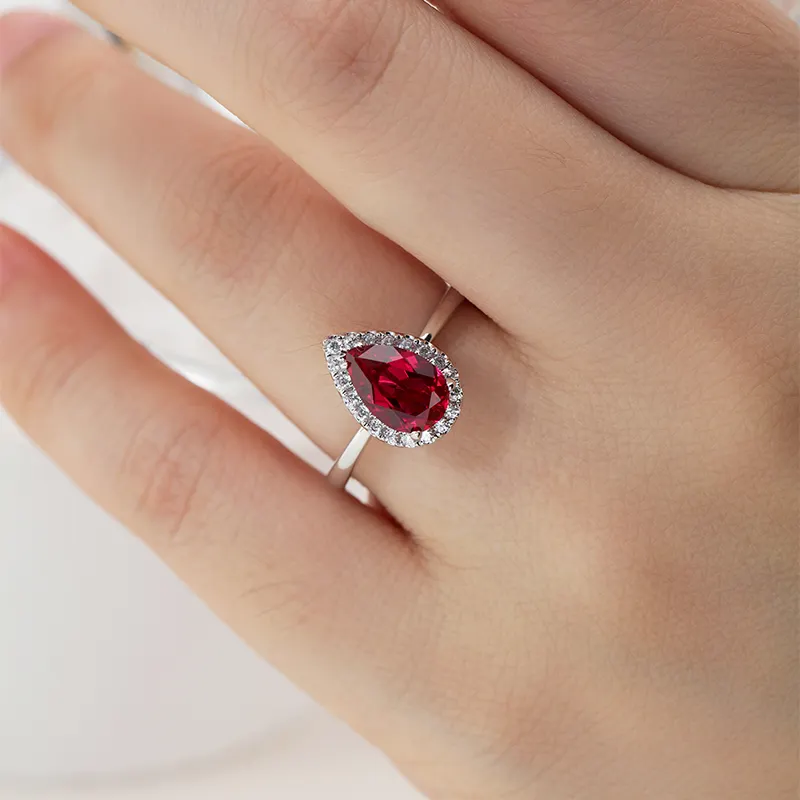 0.75 Carat Pear Shaped Ruby With Round Diamond Set Ring